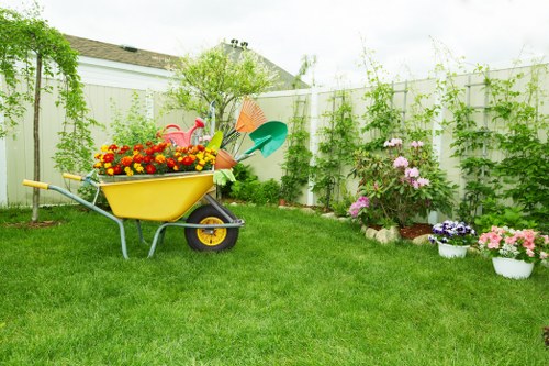 Gardener arranging compost heap in a Poplar garden